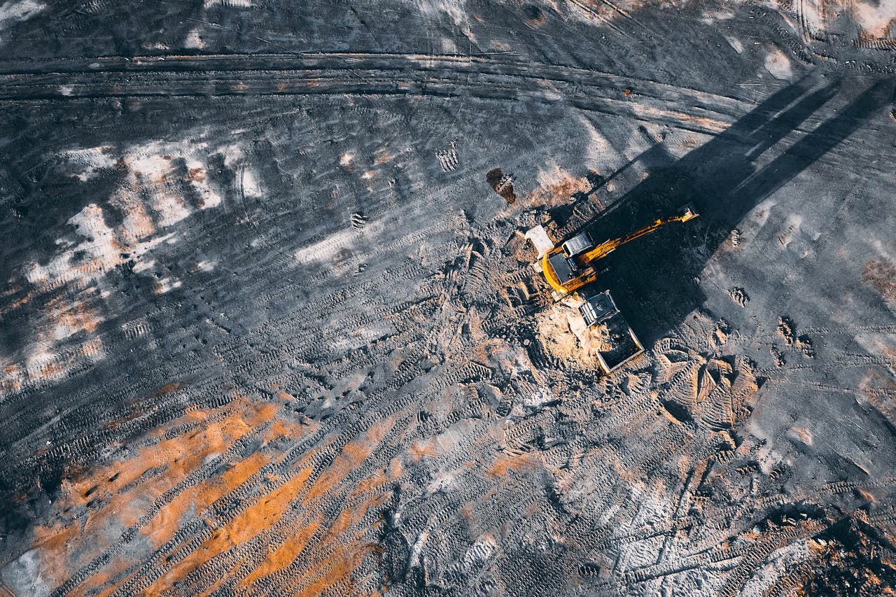 The Art of Drawing Readers In: Your attractive post title goes here Aerial view of excavator working on big coal field of powerplant located in countryside